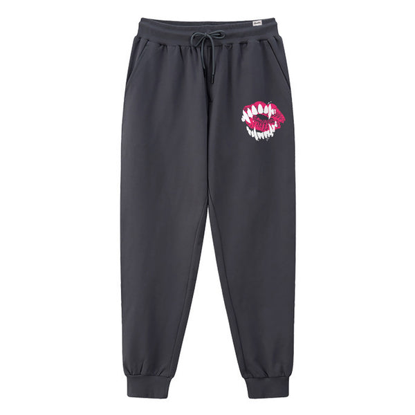 Chimei-teki - A Japanese style dark grey sweatpants featuring a design combining red lips with devilish teeth, printed on the left.