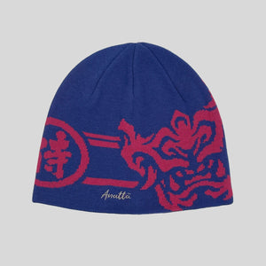 Blue beanie with hannya mask design on a gray background