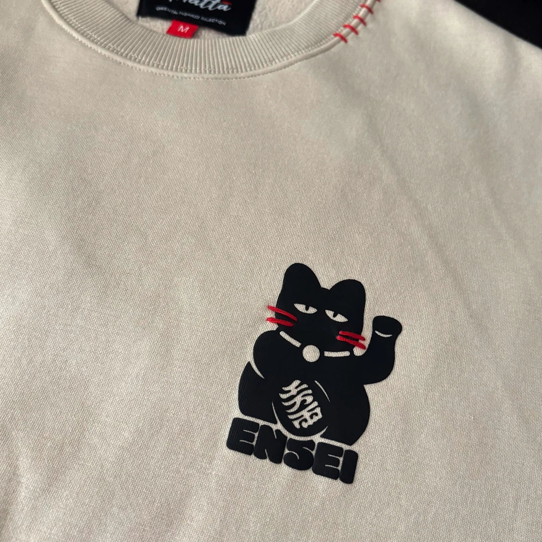 Close-up of Japanese-inspired lucky cat graphic on chest – Anatta