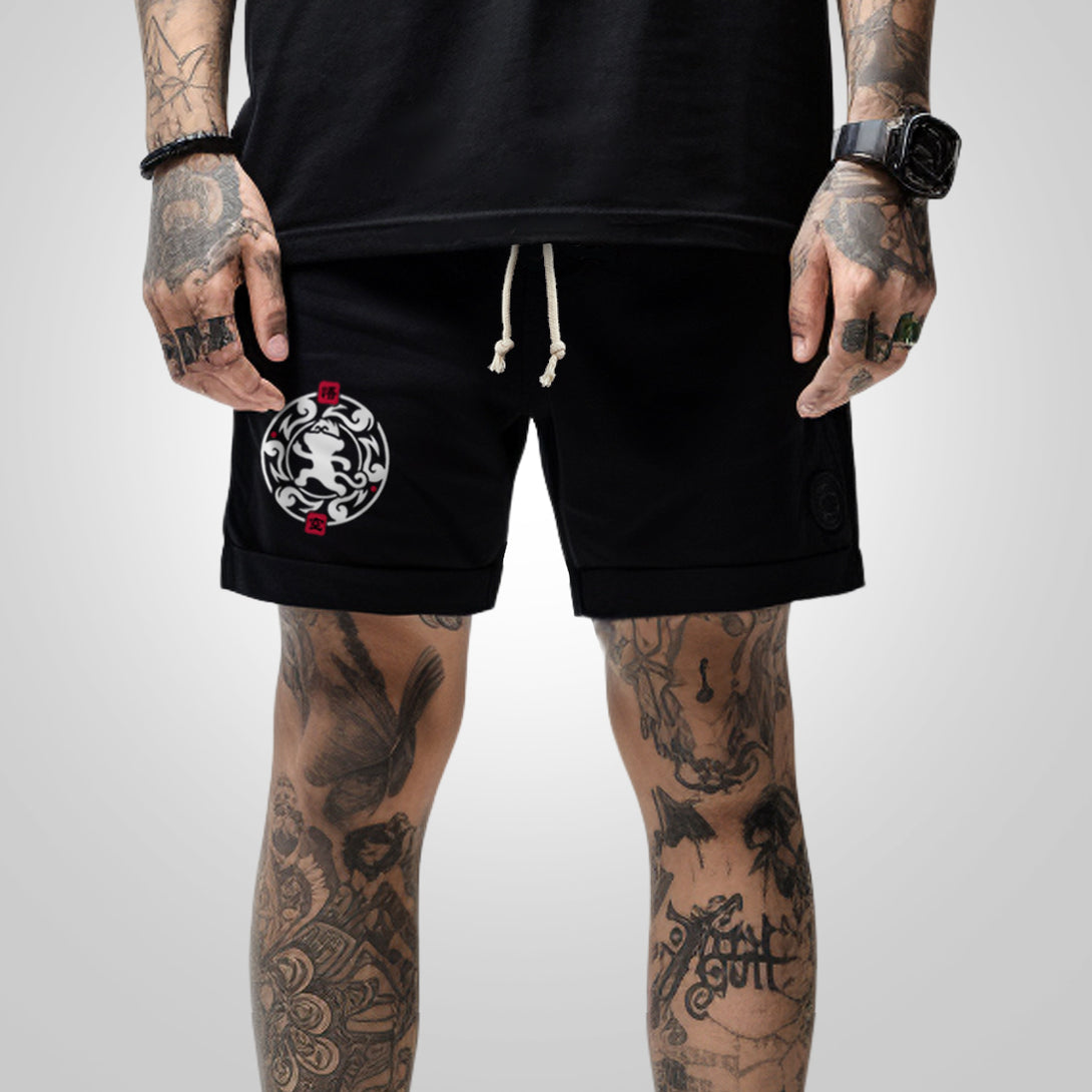 Wukong - a model wearing a black shorts, featuring a minimalist design of Wukong printed on the right.