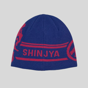 Blue beanie with red graphics and 'SHINJYA' text on a gray background
