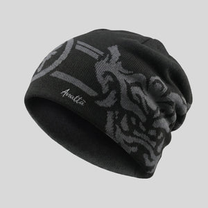 Black beanie with tribal pattern and brand logo on a gray background