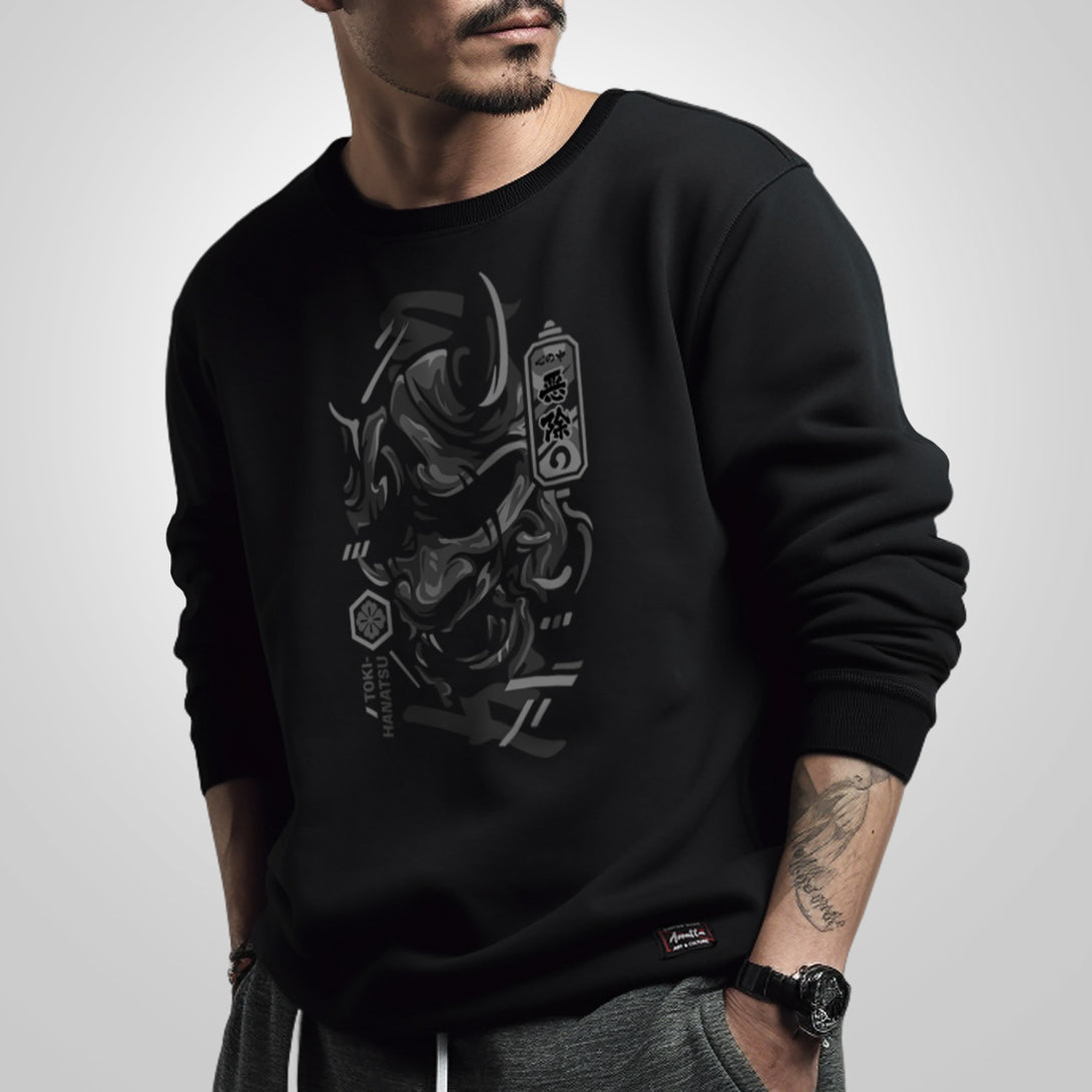 unleash emotion's complexity - a model wearing a black sweatshirt with a design of traditional Japanese demon mask on the front.