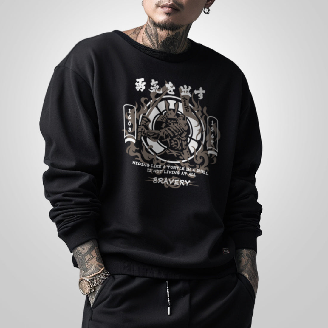 Bravery - a model wearing a black sweatshirt, featuring a design of a Japanese samurai, printed on the front.