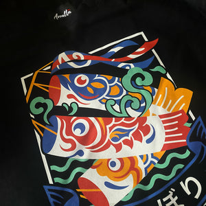 Koinobori- a close-up of a design of Japanese carp streamers printed on the front of a black sweatshirt -Anatta Streetwear