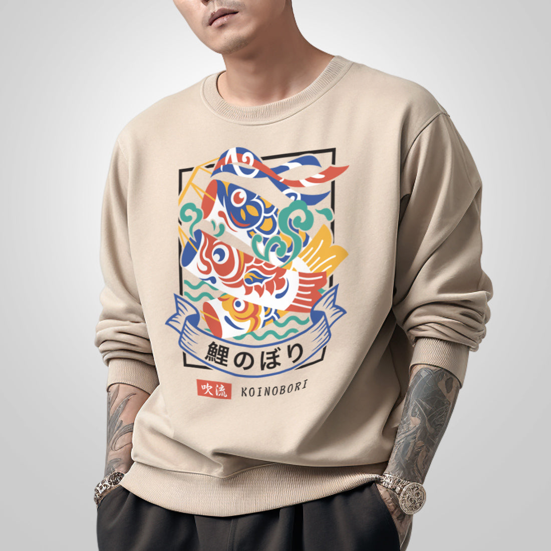 Koinobori - a model wearing a khaki sweatshirt, featuring a design of Japanese carp streamers printed on the front.