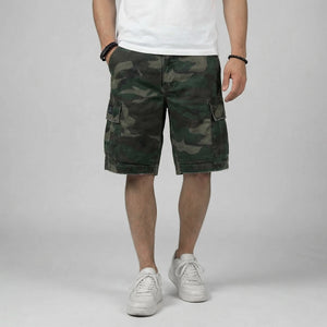front view of a model wearing camouflage shorts on a plain background - Anatta Streetwear