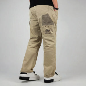 model wearing khaki cargo pants on a plain background - Anatta Streetwear
