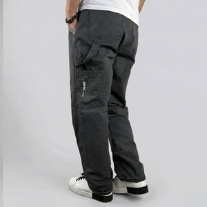 model wearing dark gray cargo pants on a plain background - Anatta Streetwear