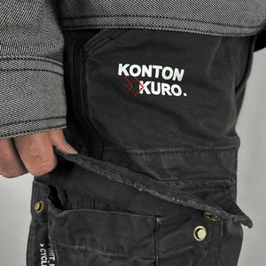 Close-up detail of small graphic print on black cargo pants - Anatta Streetwear