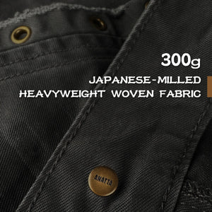 Close-up of black fabric with text about Japanese-milled heavyweight woven fabric - Anatta Streetwear
