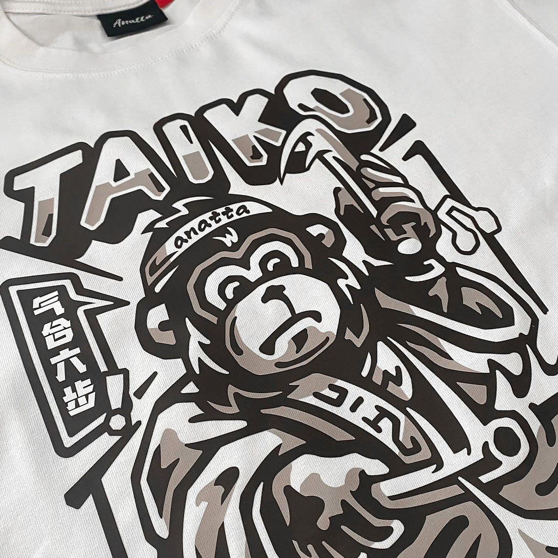 Taiko - a close-up of a graphic design featuring a monkey dressed in traditional Japanese clothing playing a taiko drum, printed on the front -1