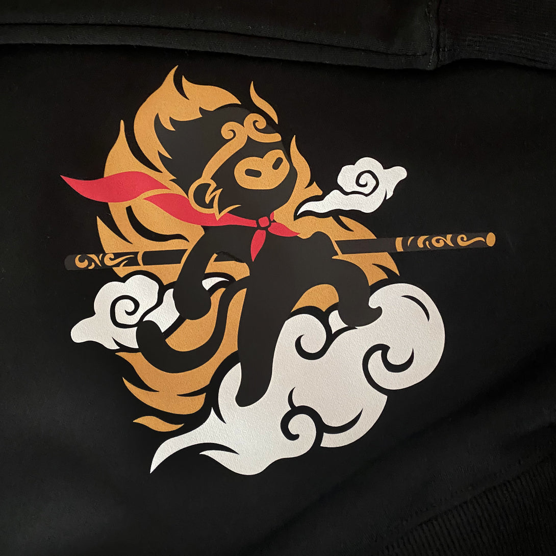 Wukong - a close-up of a design of a minimalist style Wukong printed in the bottom right corner of the black sweatshirt