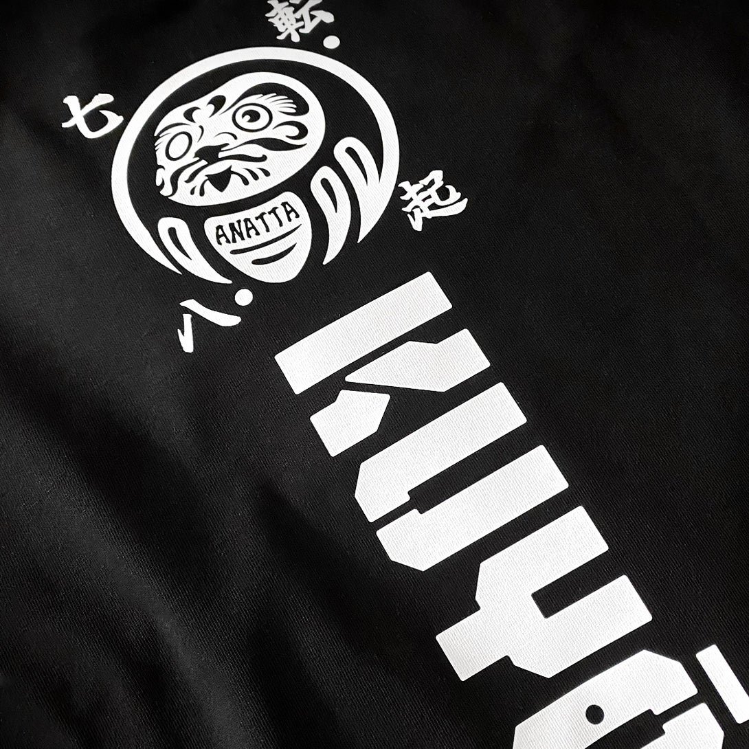 Daruma kuyō - a close-up of a design of daruma doll, printed on the back of a Japanese style black heavyweight T-shirt 