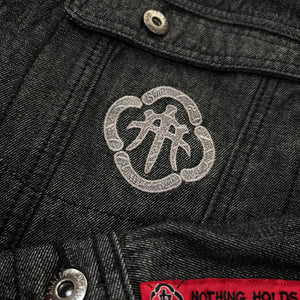 Close-up of embroidered Japanese chest emblem on the Fenikkusu dark grey denim jacket