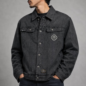 Model wearing the Fenikkusu dark grey Japanese denim jacket with embroidered chest detail