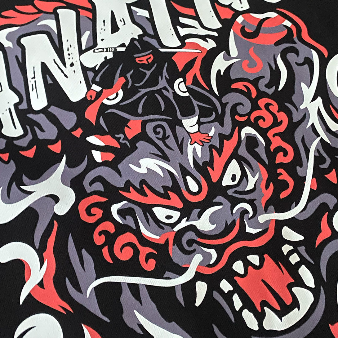 a close-up of a design showcasing a ninja controlling a mythical beast, printed on the front of a black sweatshirt-2, anatta streetwear