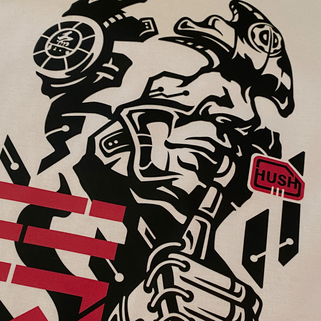 Chinmoku- a close-up of the design of a Japanese mecha-style robot face printed on the front of the khaki sweatshirt - 1