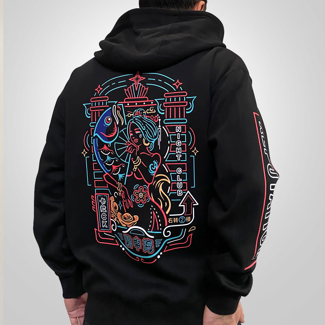 Neon - a model wearing a black hoodie with the design inspired by vintage Shanghai neon lights printed on the back-back view-1