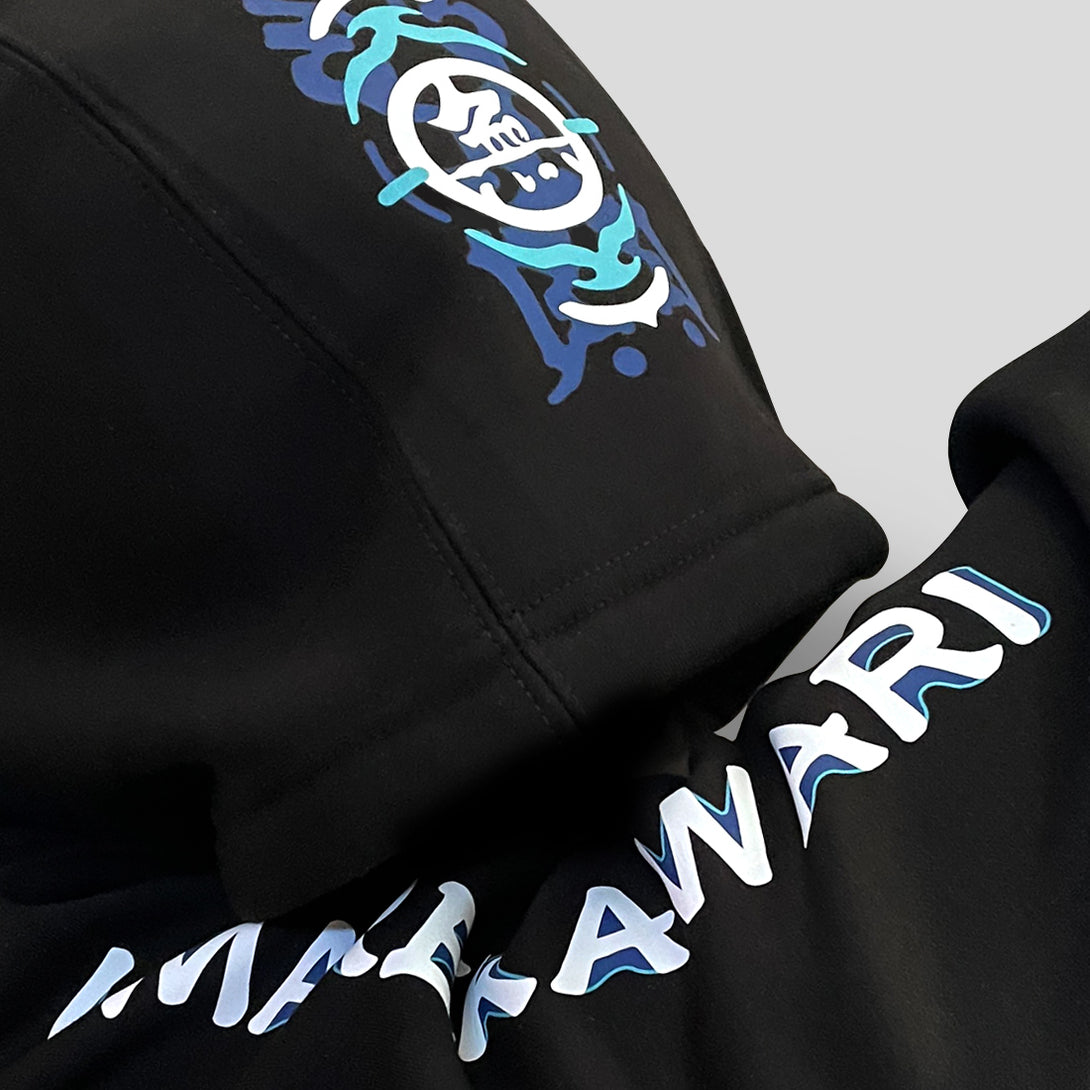 Umarekawari - a close-up of the graphic designs printed on hood and sleeve of the Japanese style black hoodie