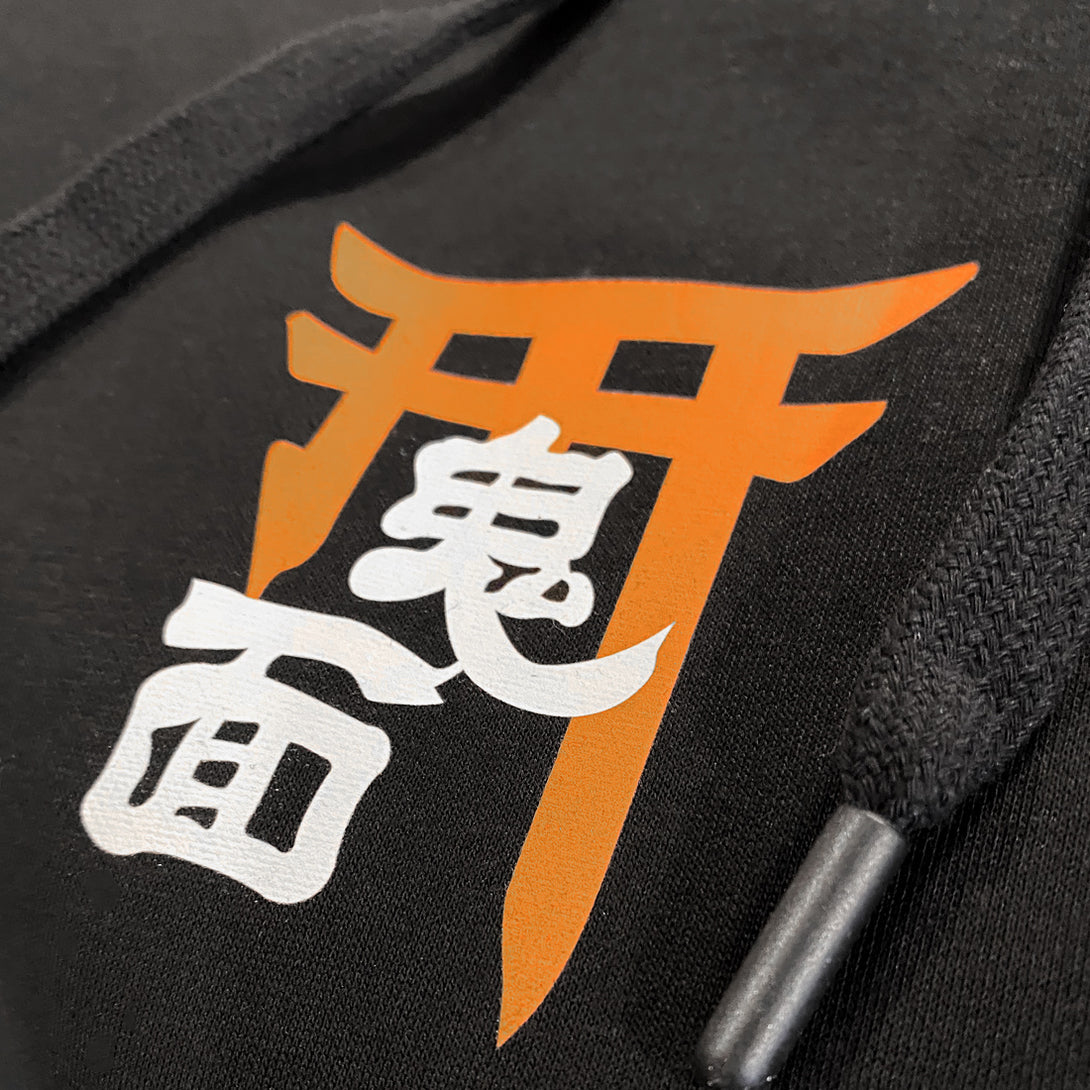 Oni mask - a close-up of the graphic design printed on the front of the Japanese style black hoodie