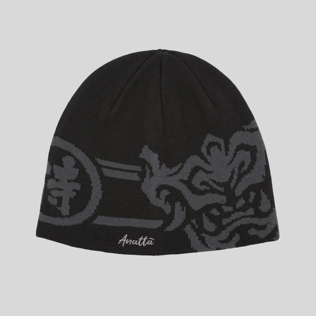Black beanie with gray patterns and 'Anatta' branding on a light gray background