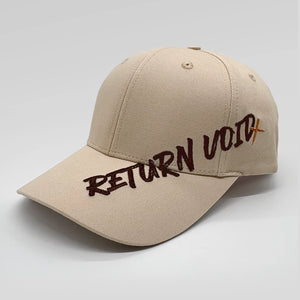 A beige baseball cap with 'RETURN VOID' embroidered across the front in dark brown and orange lettering, set against a plain light gray background.