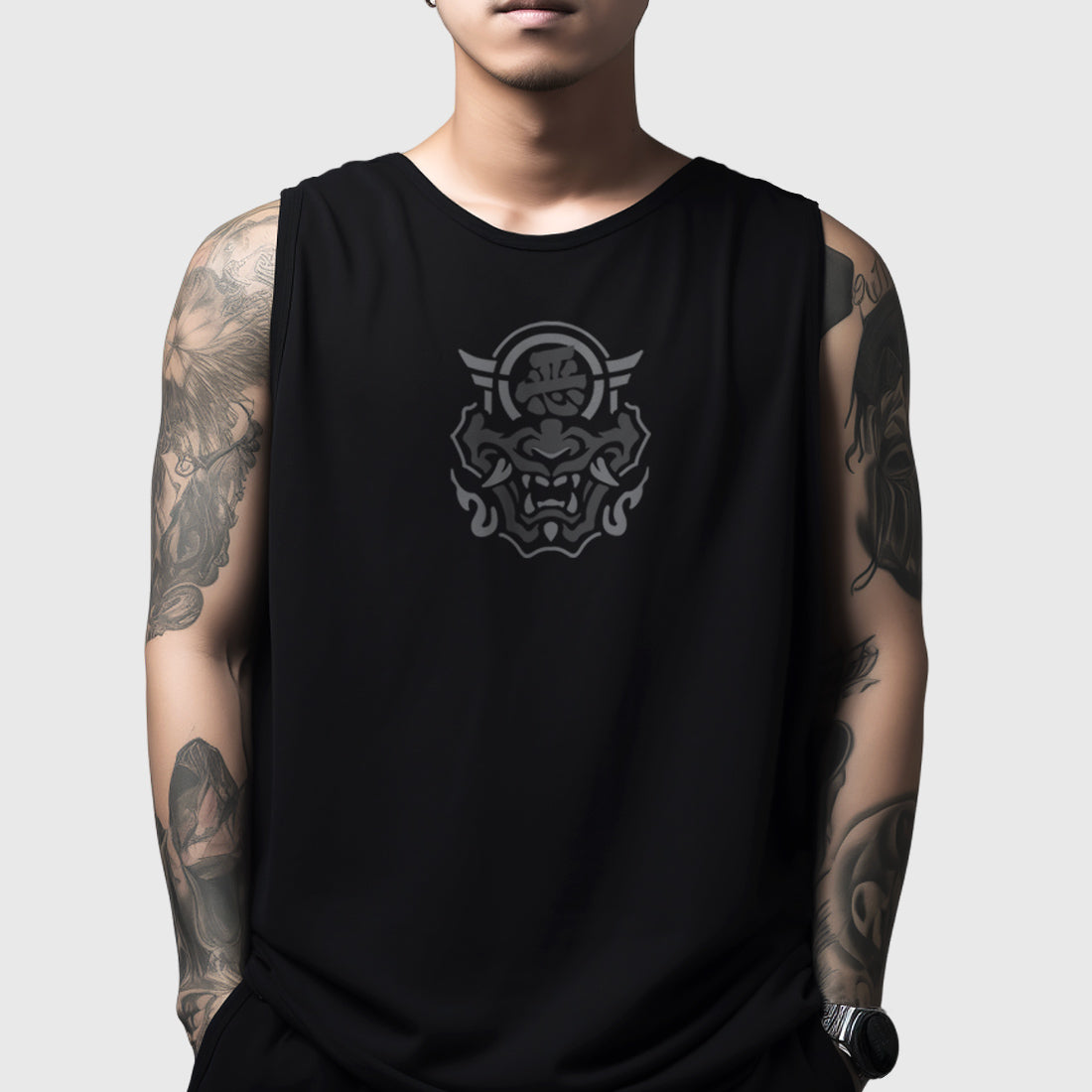 A model wearing a Japanese style black tank top featuring a graphic design of the Japanese Hannya mask, printed on the front.