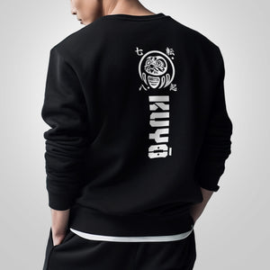 Daruma kuyō- a model wearing a black sweatshirt, featuring a design of daruma doll, printed on the back-back view