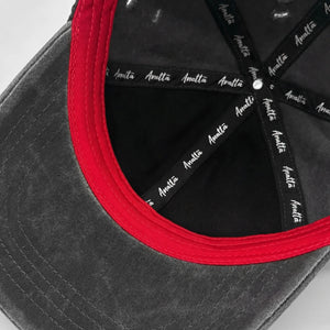 Grey cap with red rim and black strap featuring 'Anatta' branding on a light gray background - Anatta Streetwear