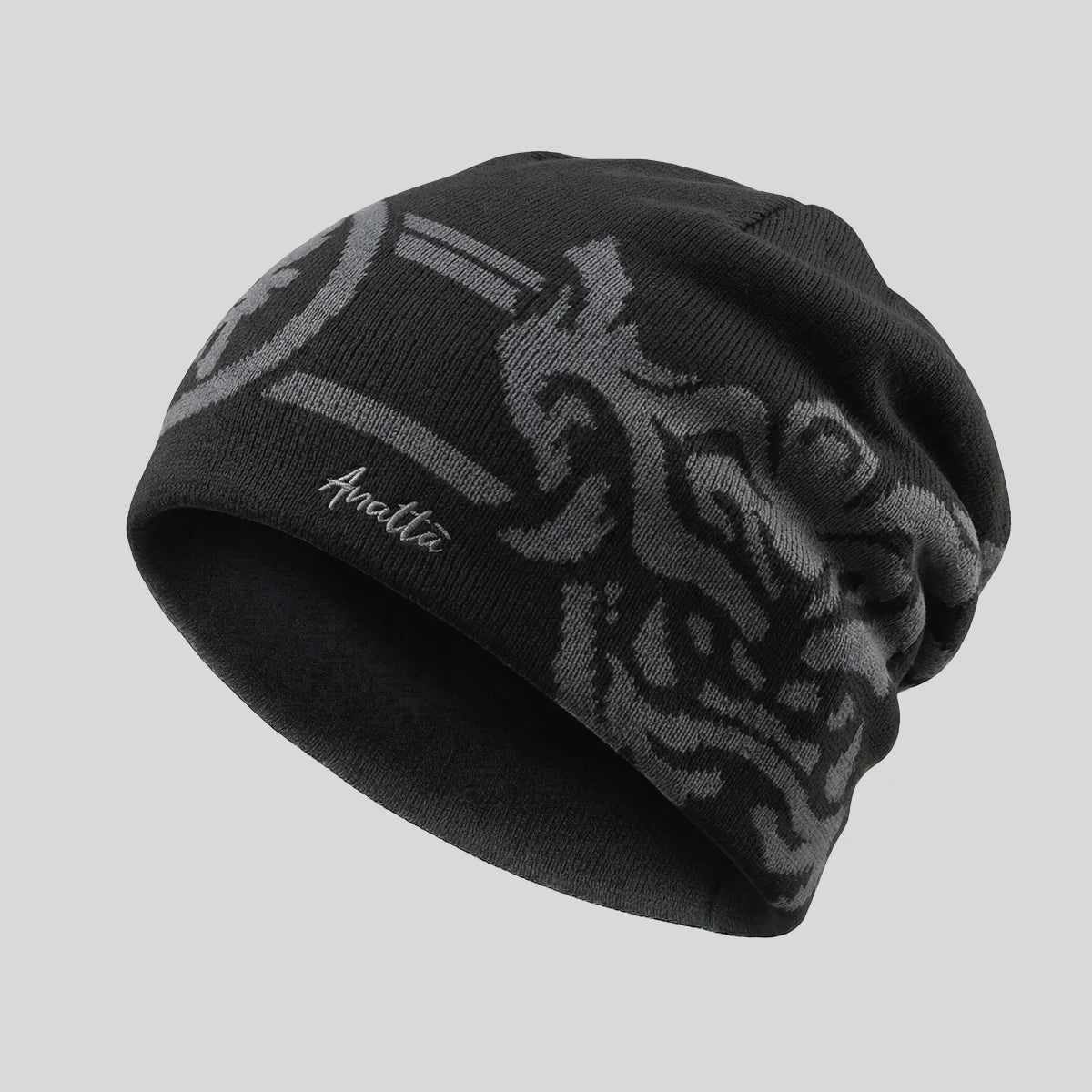 Black beanie with tribal pattern and brand logo on a gray background