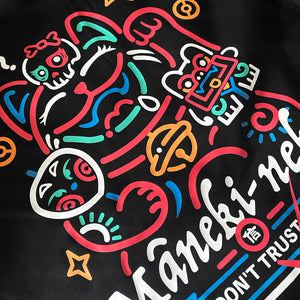 a close-up of a design of a lucky cat printed on the back of a Japanese style black hoodie