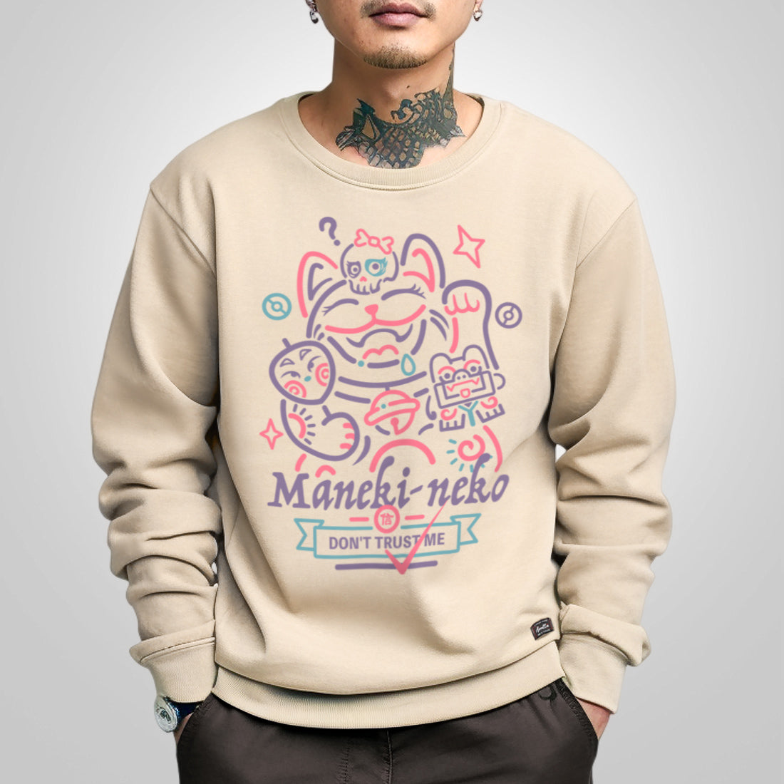 Not to believe in luck - a model wearing a khaki sweatshirt, featuring a Japanese luck cat design printed on the front