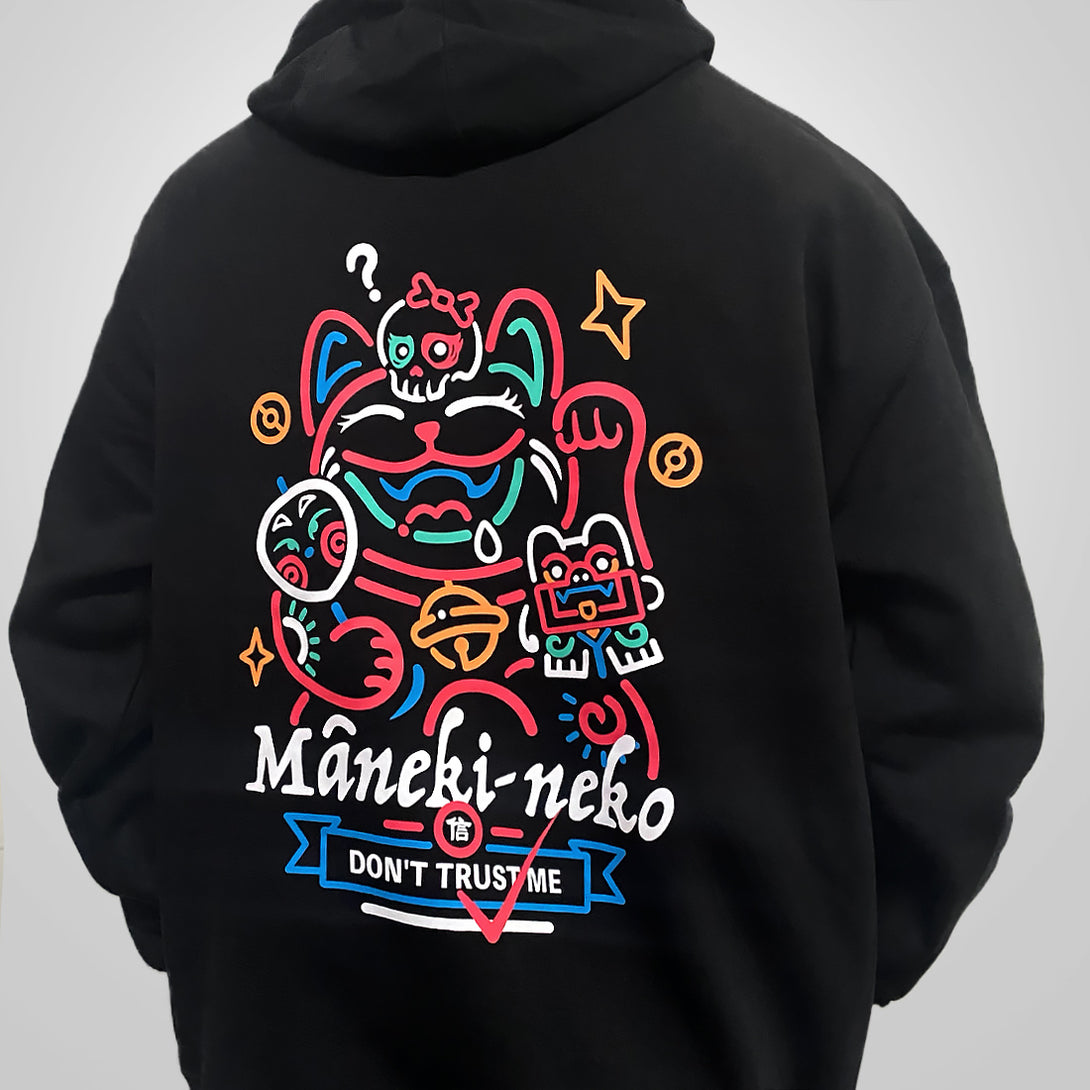 a model wearing a black hoodie with the design of a lucky cat printed on the back-back view