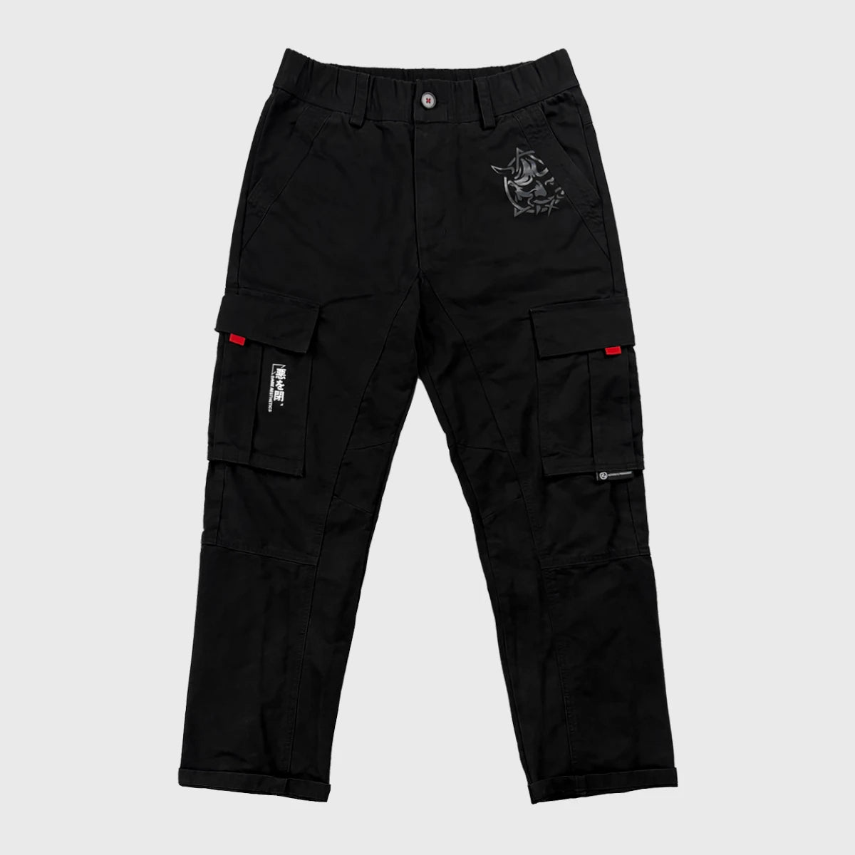 Black cargo pants with red accents on a light grey background - Anatta Streetwear