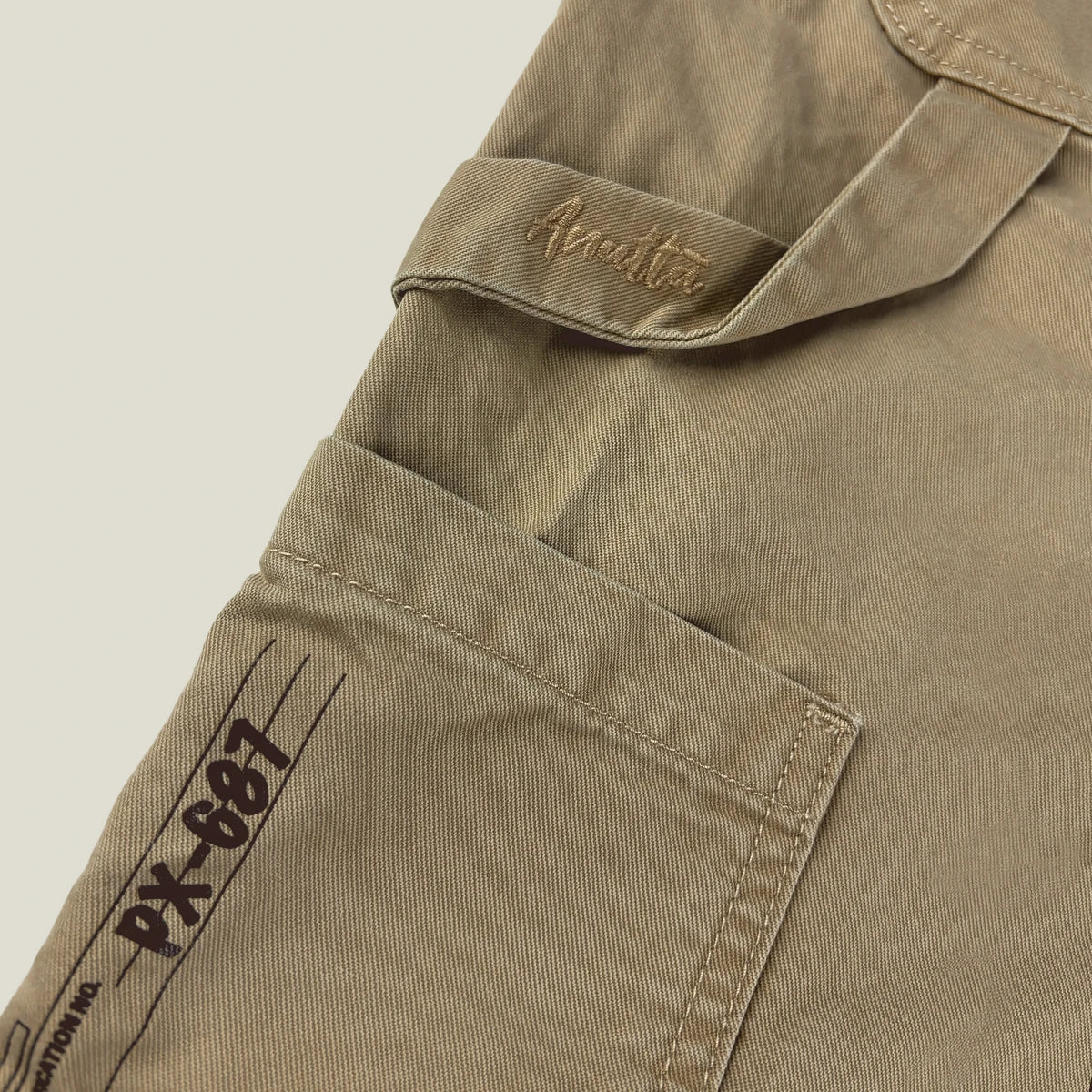 Close-up of Anatta logo embroidery on the left side