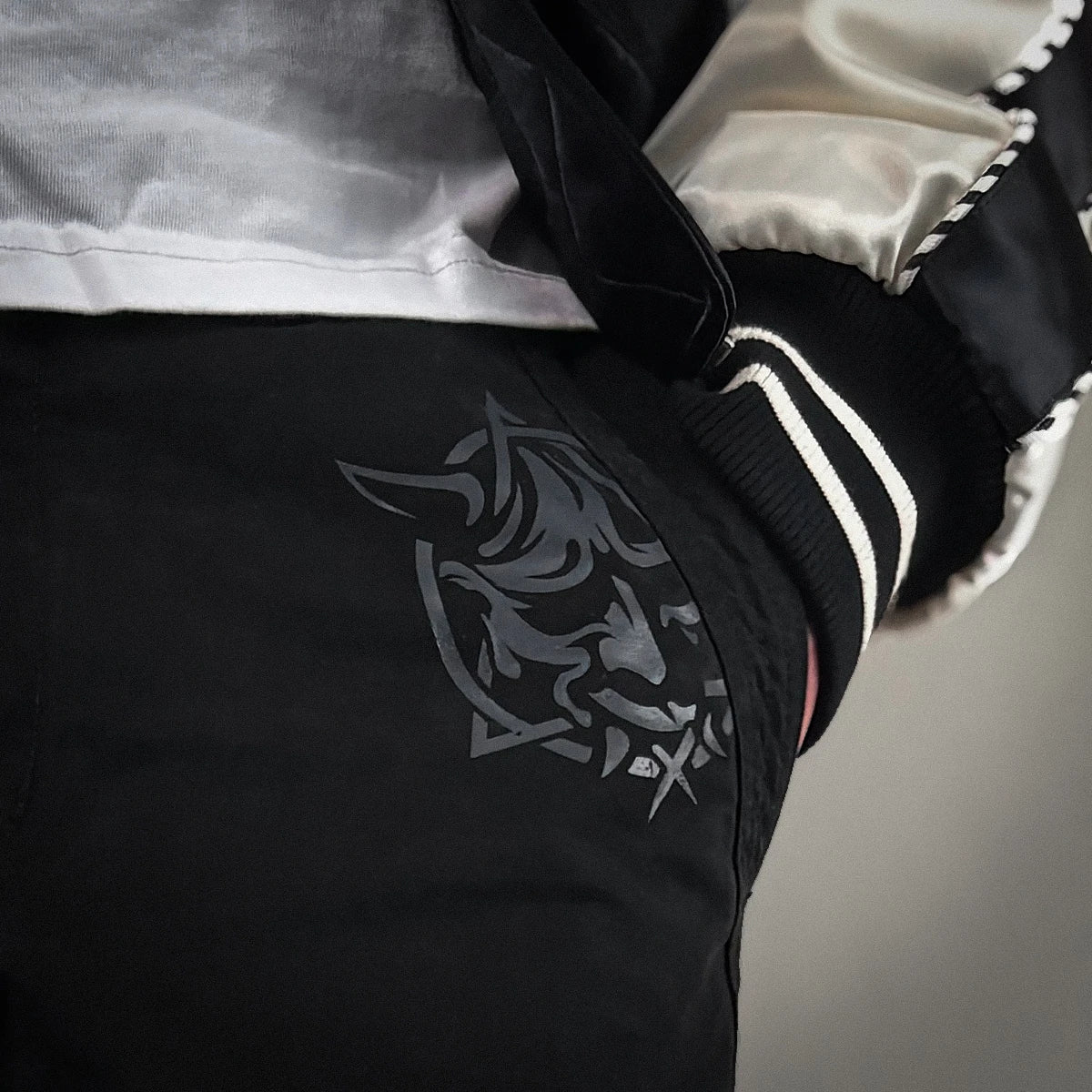 Close-up of Hannya mask print on the black cargo pocket - Anatta Streetwear