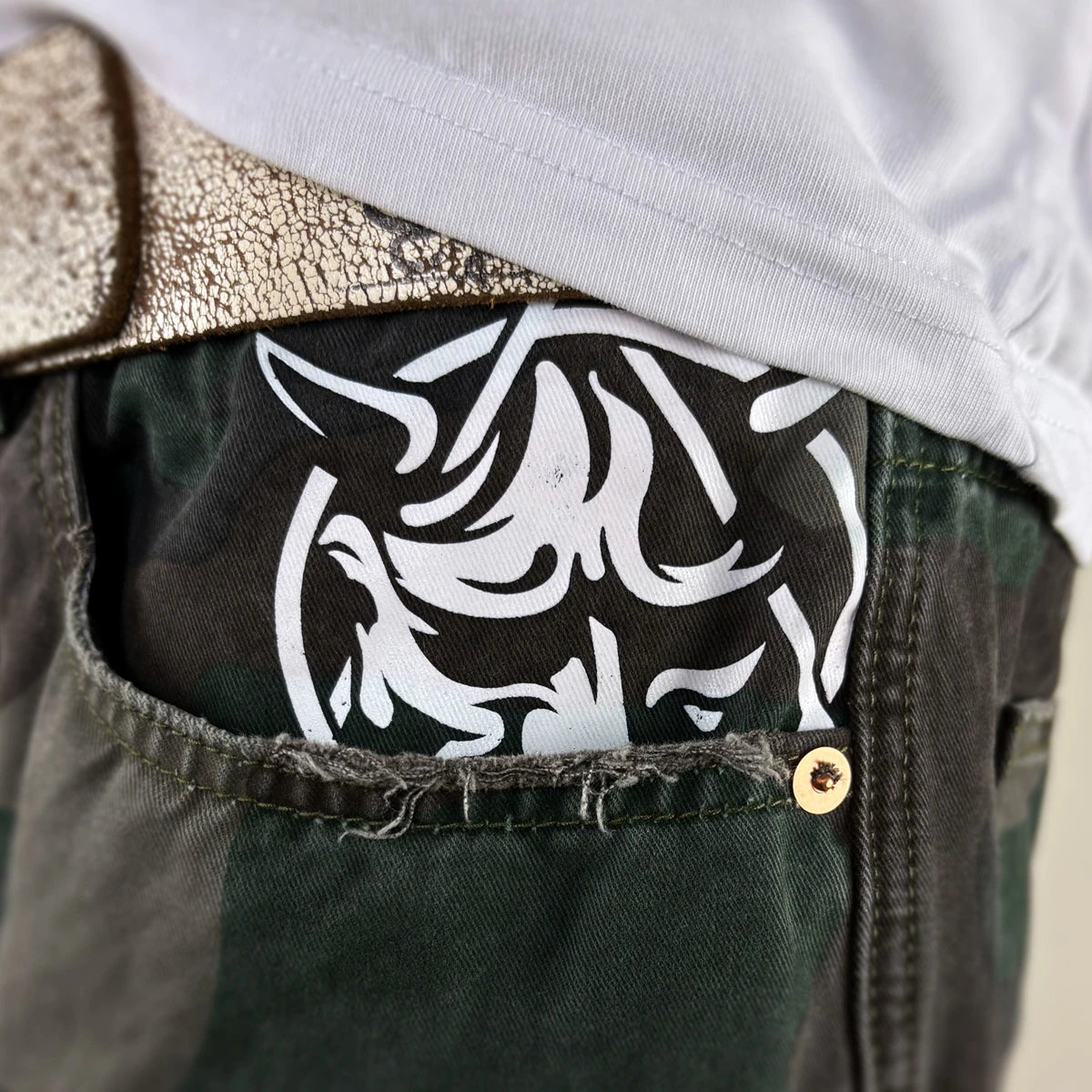 Close-up detail of the white Hannya design on the shorts pocket - Anatta Streetwear