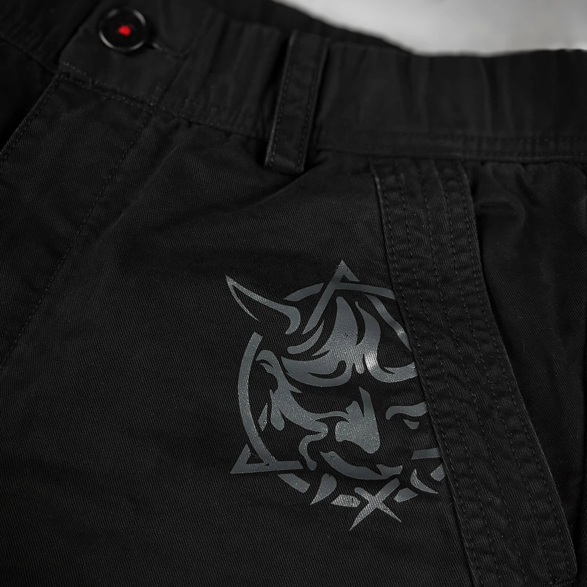 Black cargo pants with metallic Hannya mask design on the pocket – Anatta Streetwear
