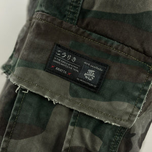 Close-up of camouflage cargo pocket featuring Anatta label