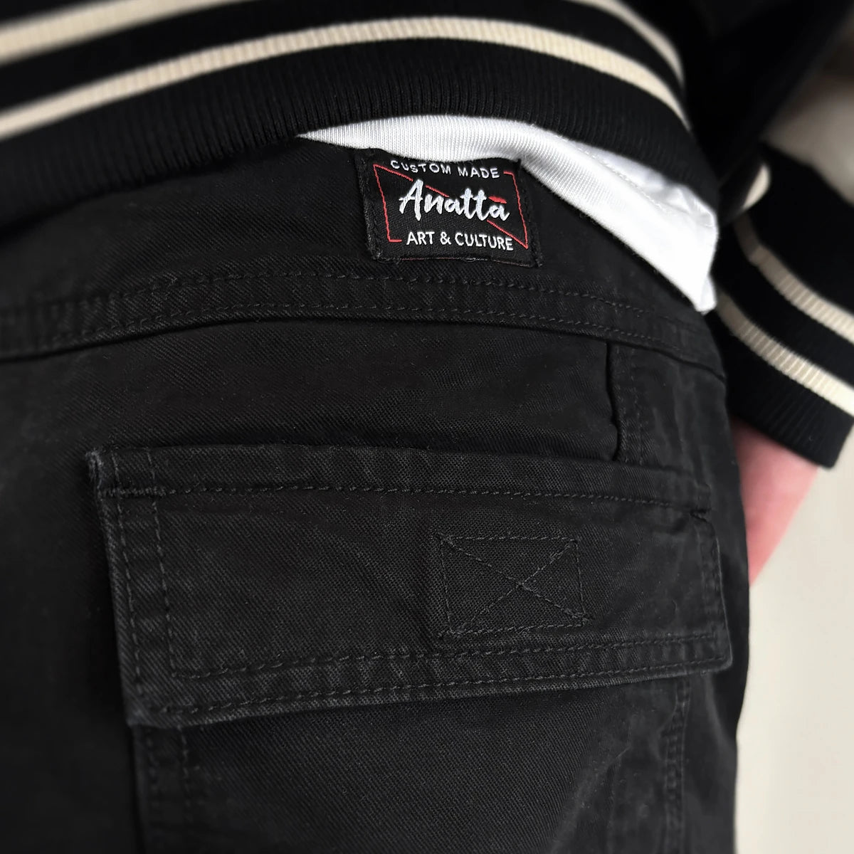 Black cargo pants with Anatta brand label on the pocket - Anatta Streetwear