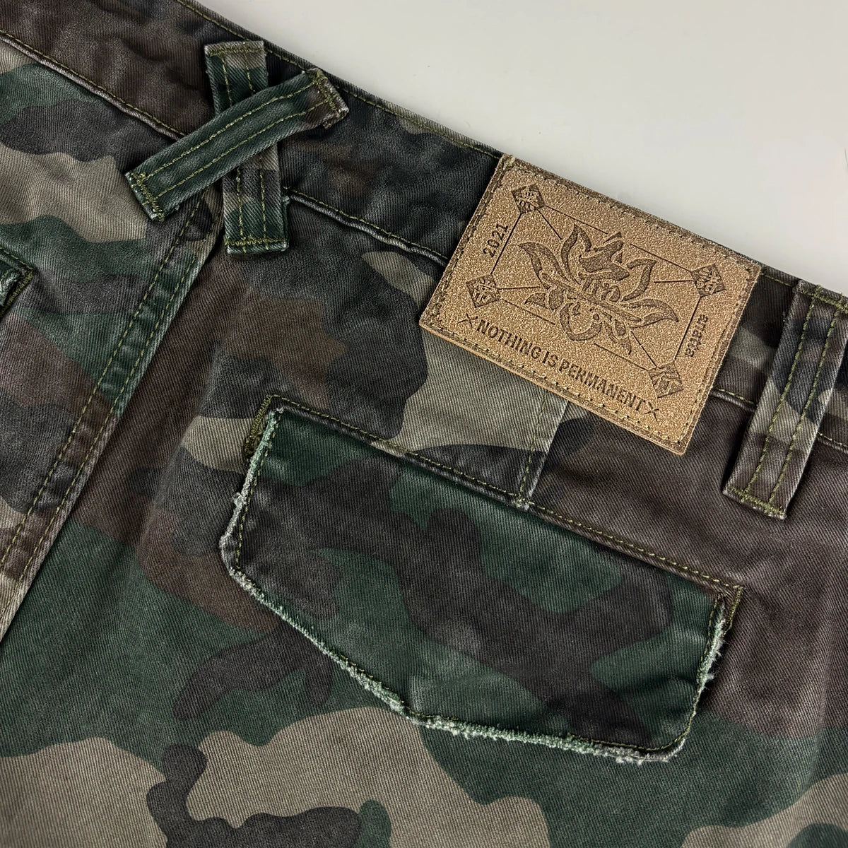 Camouflage pants with leather patch on a white background - Anatta Streetwear