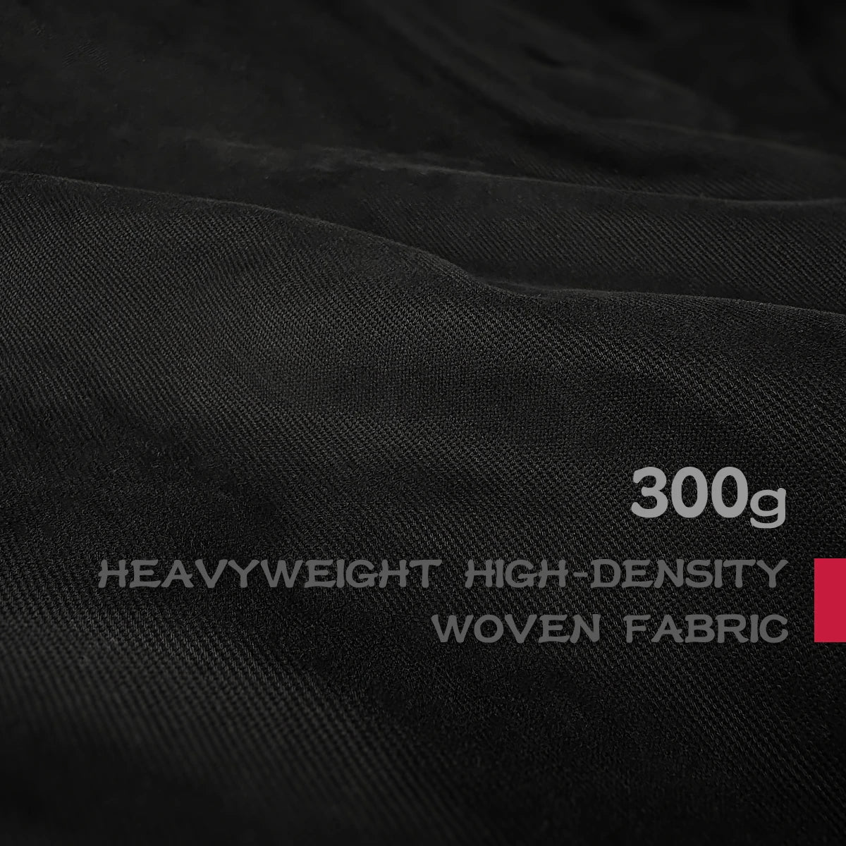 Close-up of black fabric with text indicating '300g Heavyweight High-Density Woven Fabric'. - Anatta Streetwear