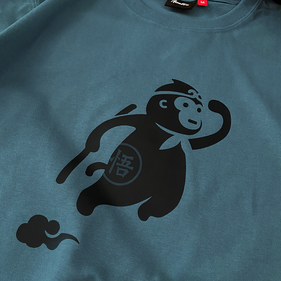 a close-up of a cute design of the oversized wukong, printed on the front of a bluestone heavyweight T-shirt -2 - Anatta Streetwear