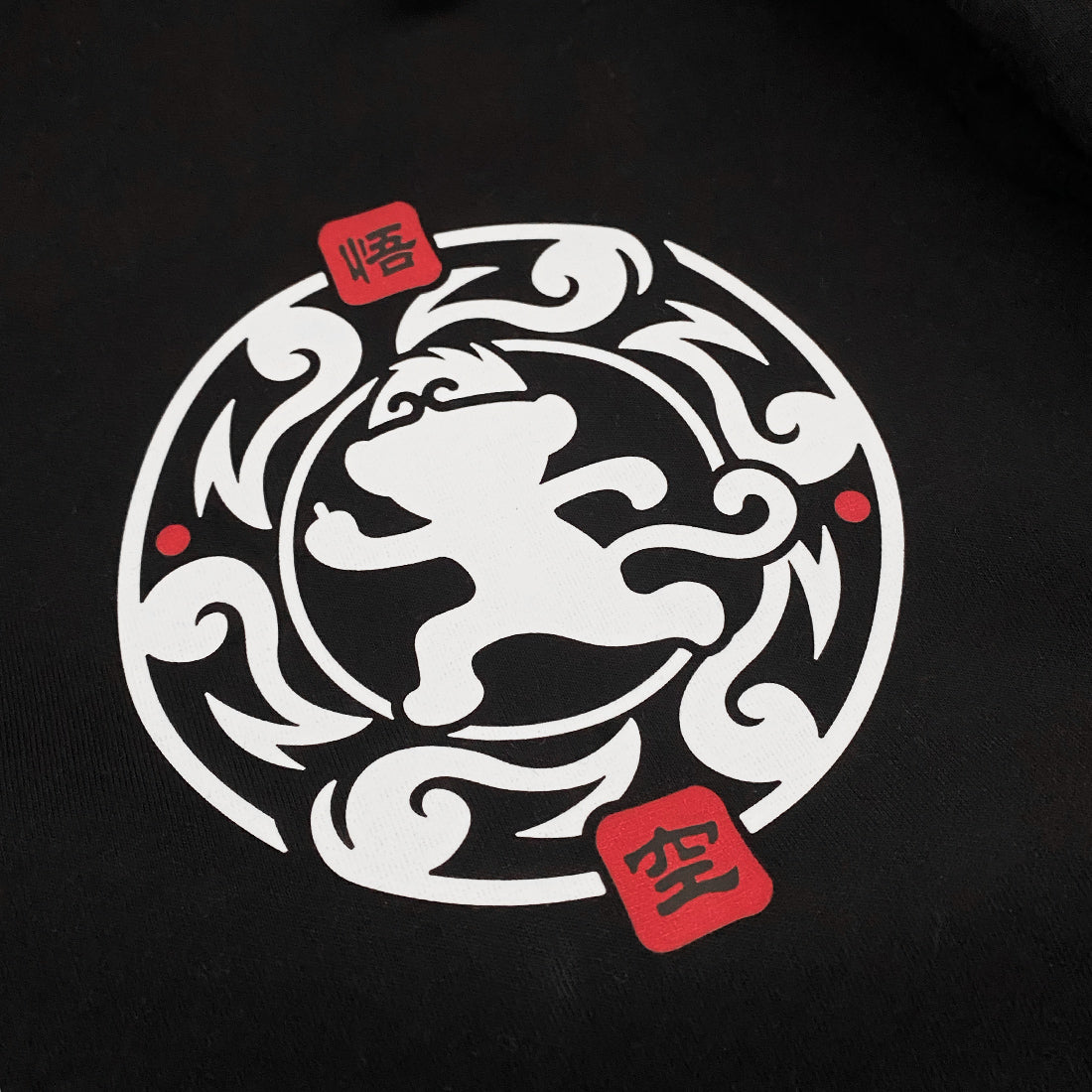 Wukong - a close-up of a minimalist design of Wukong, printed on the left of a black tank top