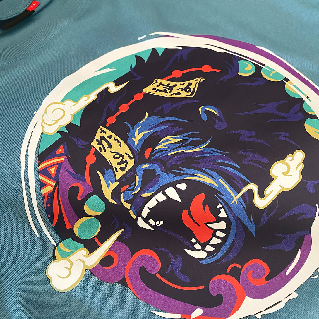 Roaring Ape - a close-up of a graphic design of the ape subdued by Daoist talismans, printed on the front of a Japanese style blue stone heavyweight T-shirt -1