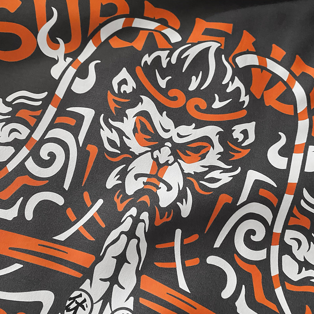 The close-up of a graphic design of Sun Wukong Surrendering, printed on the back of a Japanese style dark grey hoodie- 2 - Anatta Streetwear