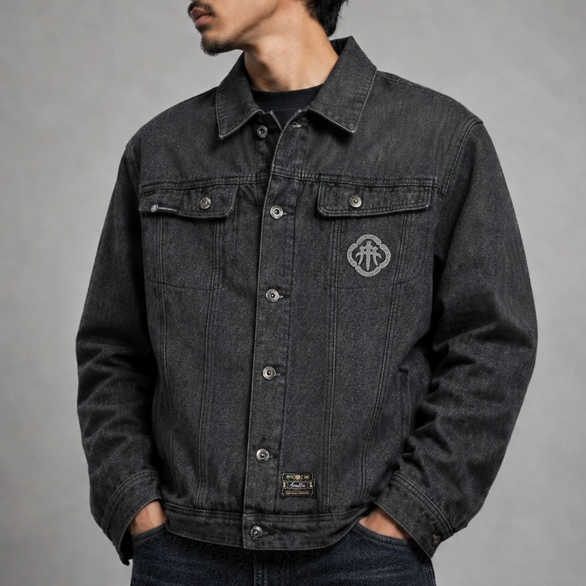 Model wearing the Fenikkusu dark grey Japanese denim jacket with embroidered chest detail