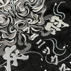Close-up of detailed Japanese phoenix embroidery on the Fenikkusu dark grey denim jacket