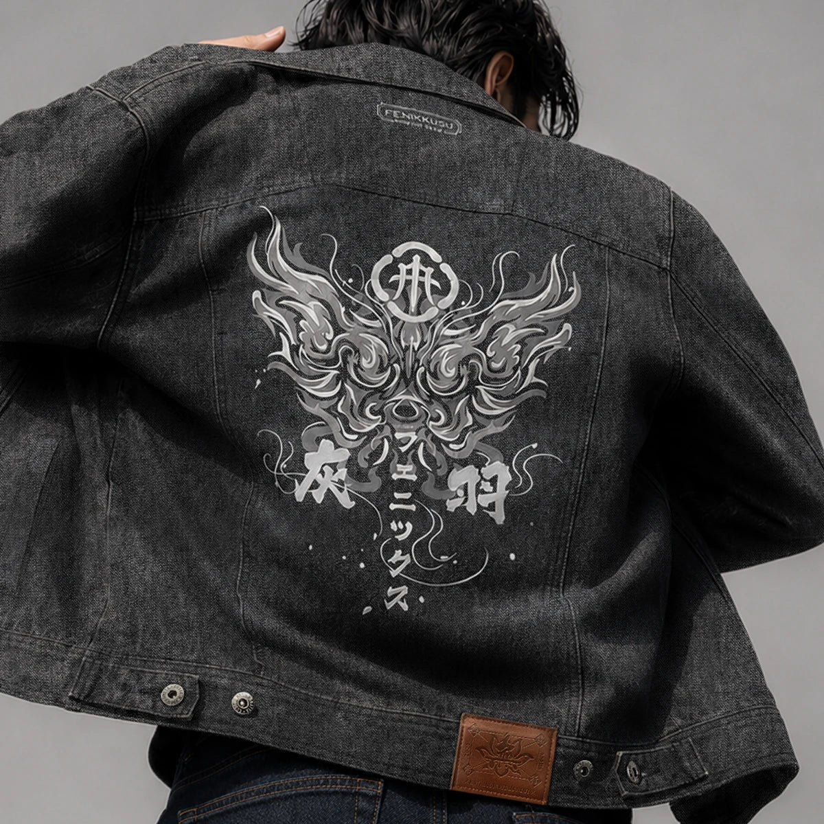 Close-up back view of the Fenikkusu dark grey Japanese denim jacket with large phoenix embroidery